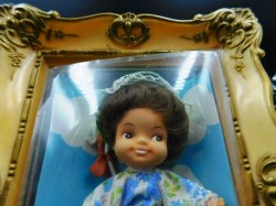 mini doll in frame green tops